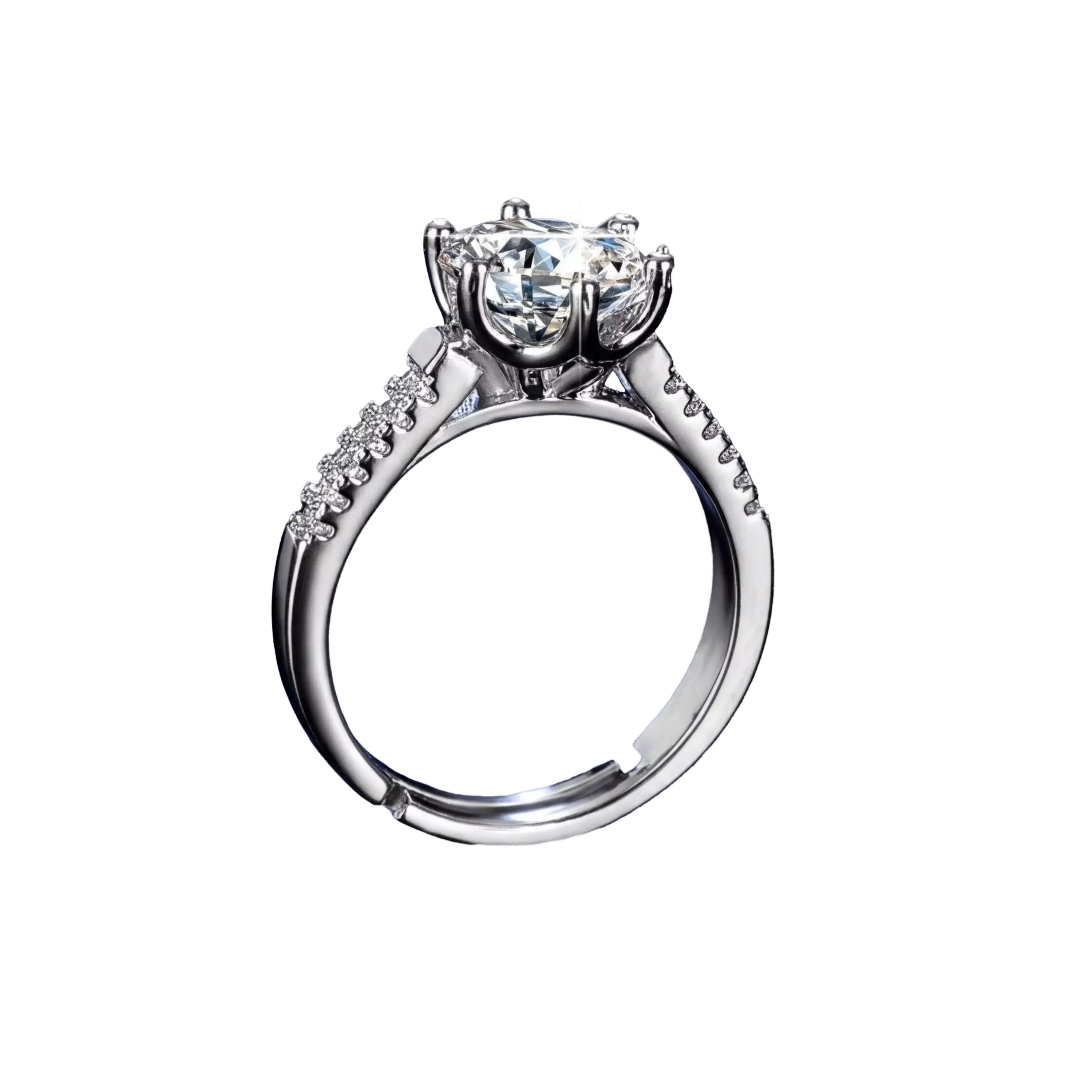 A close-up of a diamond engagement ring with a large central diamond surrounded by smaller diamonds on either side, set in a silver band, against a dark background.